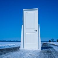 white wooden door near body of water during daytime
